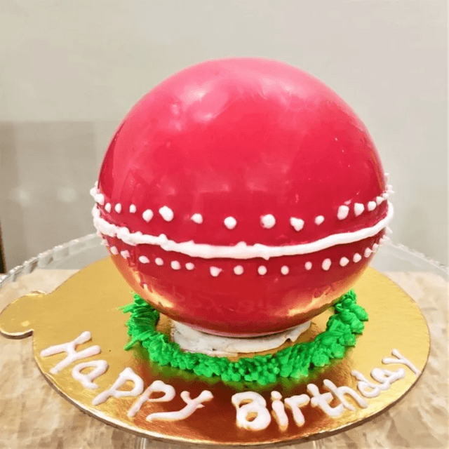 Cricket ball pinata cake